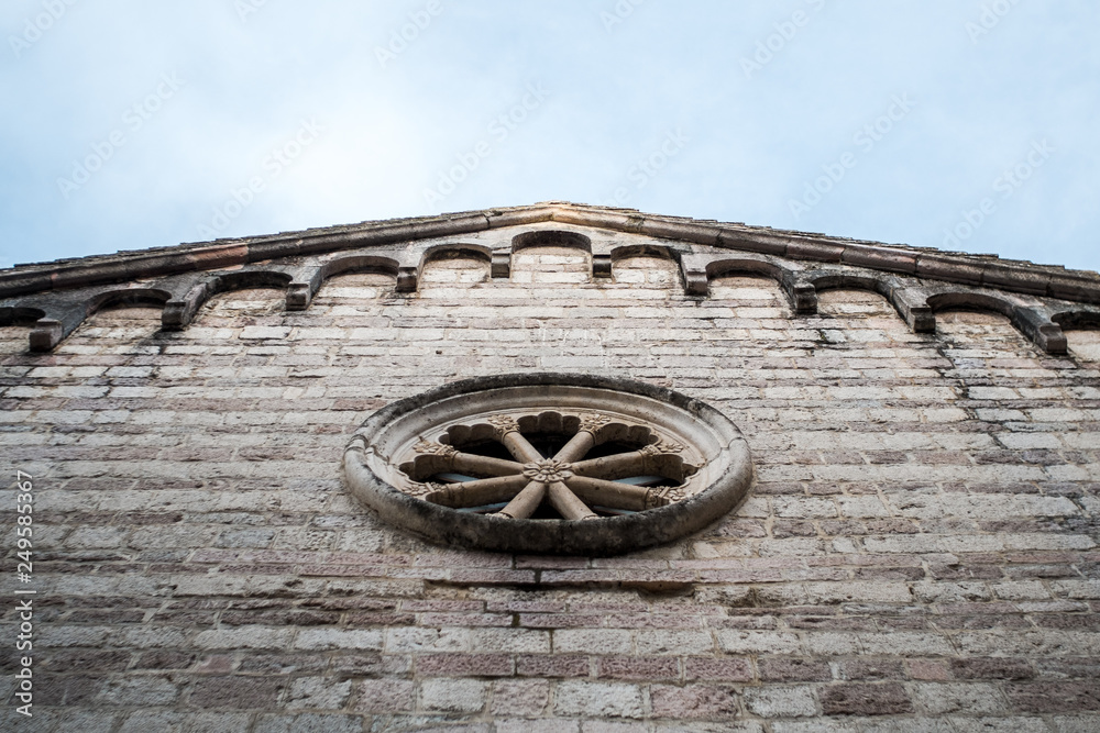 Stone wall with rose window of St Mary's Collegiate Church in Kotor, Montenegro.