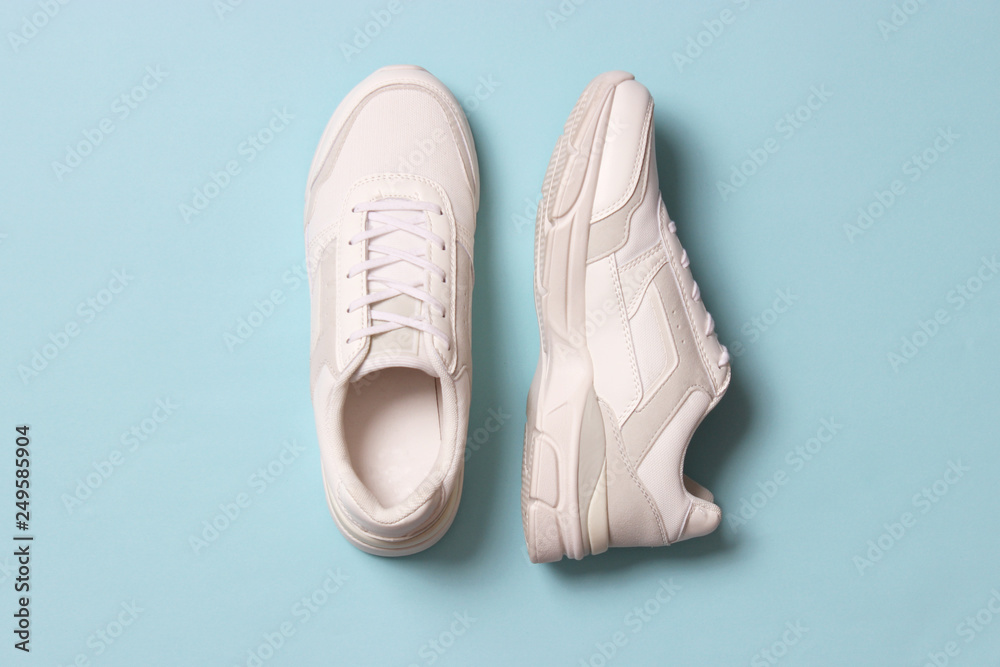 women's sneakers on a colored background top view. Women's shoes. - obrazy, fototapety, plakaty 