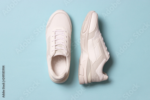women's sneakers on a colored background top view. Women's shoes.