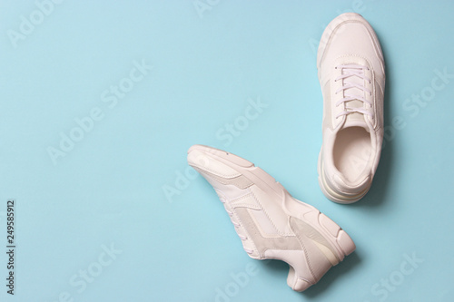 women's sneakers on a colored background top view. Women's shoes.