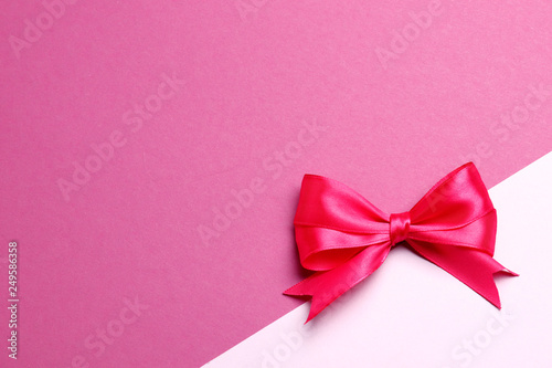 Pink bow on a pink background with place for text. Celebration