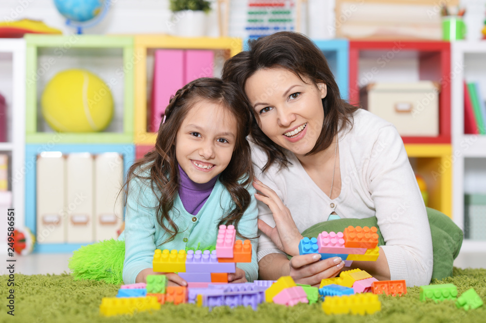 Portrait of cute girl playing with plastic blocks Portrait of cute girl playing with plastic blocks