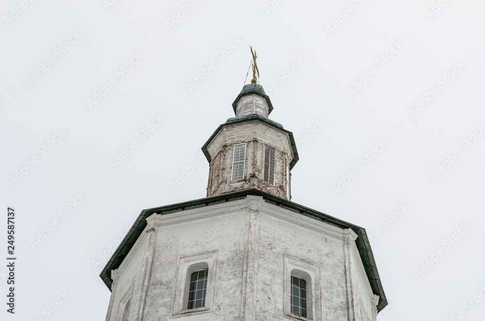The bell tower of the monastery on a cloudy day. Orthodox architecture of the monastery The bell tower of the monastery on a cloudy day. Orthodox architecture of the monastery