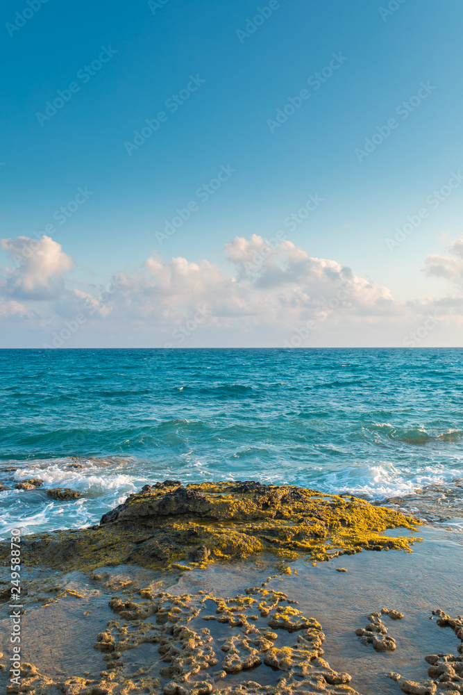 Sea, rocks, waves and blue sky