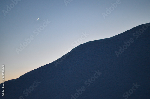 moon in the sky and fresh snow