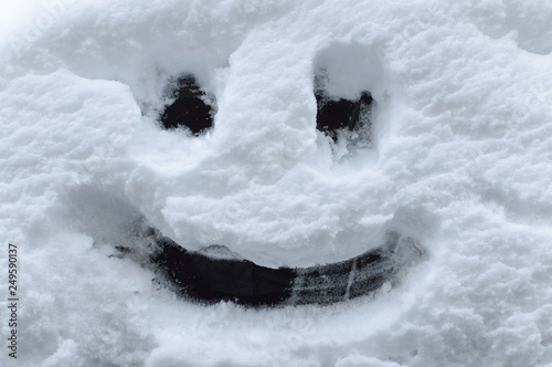 Smiley face drawing in the snow