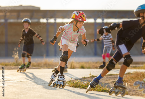 A girl training inline skating with other children