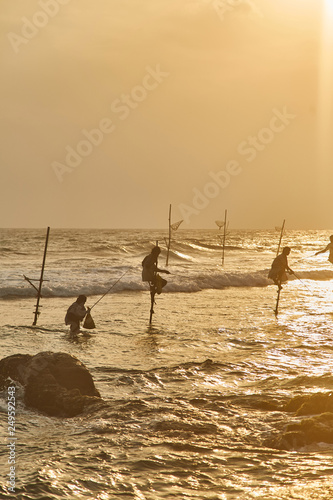 Fishermen in Sri Lanka fishing at sunset  photo