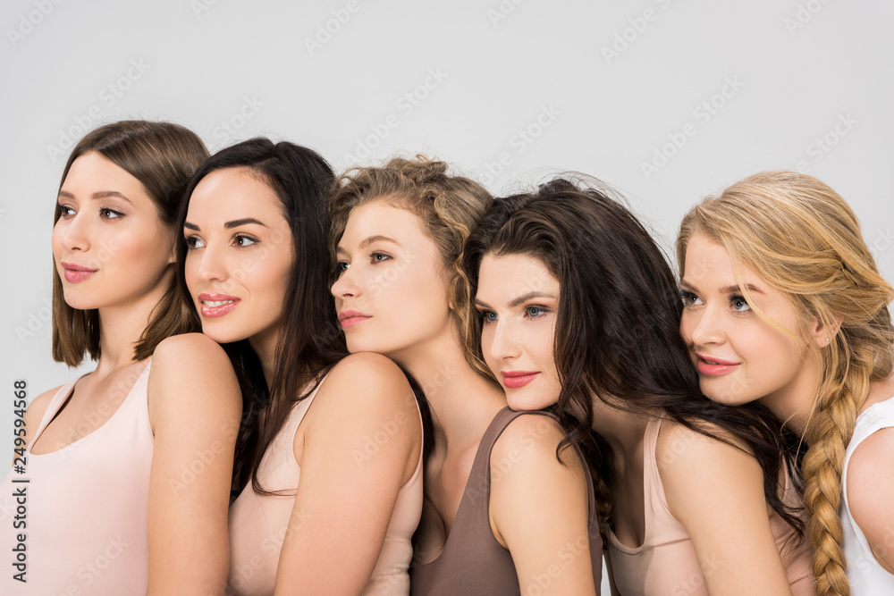 pretty young women putting heads on shoulders of each other isolated on grey pretty young women putting heads on shoulders of each other isolated on grey