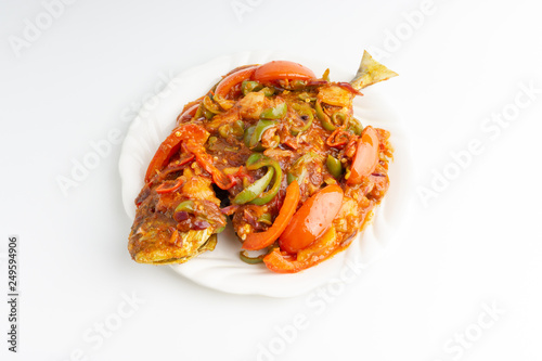 Sweet sour fried fish on white background with selective focus and crop fragment photo
