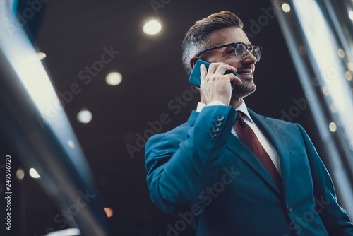 Attractive man speaking on telephone and smiling © Yakobchuk Olena