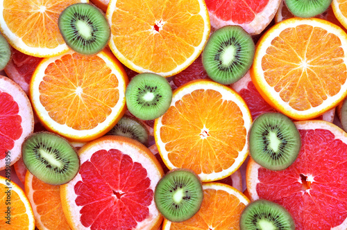 Fresh ripe sweet citrus fruits colorful background: orange, grapefruit, lime, lemon 