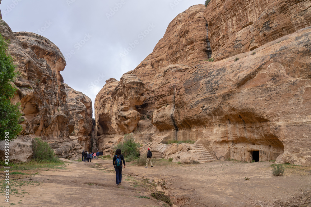Toursts explore ancient tombs in Little Petra, Jordna Toursts explore ancient tombs in Little Petra, Jordna