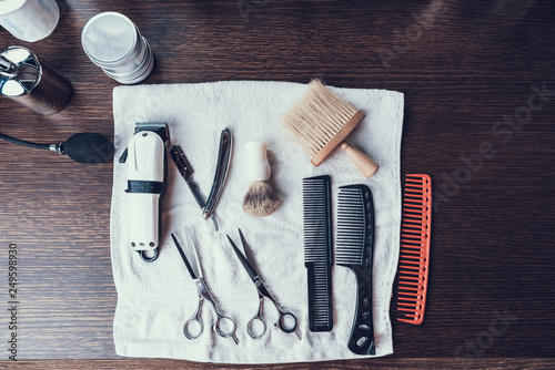 Set of different hair cutting tools lying on towel