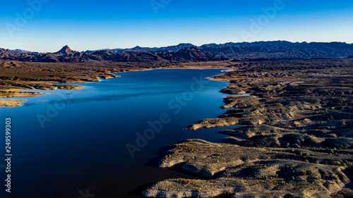 Aerial, drone view of Alamo Lake, Arizona in the remote desert near Wenden with vivid blue water and sky with Alamo Dam