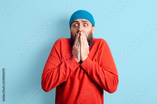 Emotional caucasian man looking on something terrible