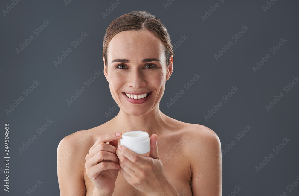 Gorgeous lady with cream in hands smiling nice