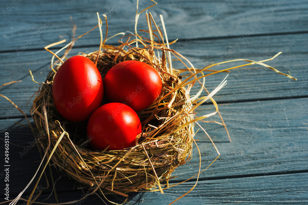 Easter background with bright red Easter eggs and spring flowers. Top view with copy space Easter background with bright red Easter eggs and spring flowers. Top view with copy space