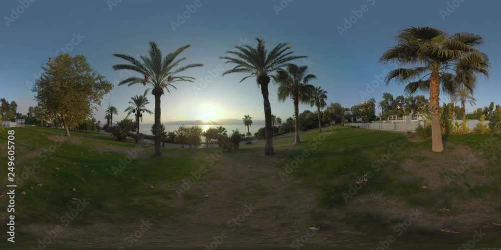 360 VR video. Resort area on Antalya coast, Turkey. Scene with greenspace, outdoor swimming pool, sea and sun setting behind the mountains 360 VR video. Resort area on Antalya coast, Turkey. Scene with greenspace, outdoor swimming pool, sea and sun setting behind the mountains