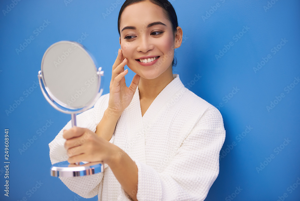 Happy young lady satisfying of her reflection Happy young lady satisfying of her reflection