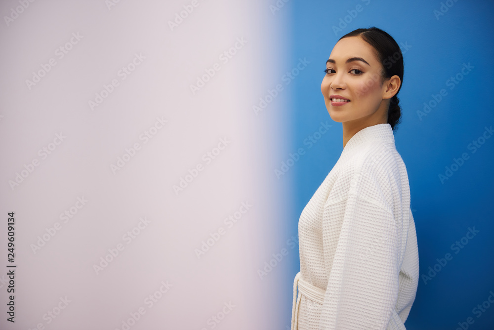 Joyful asian lady walk indoors in spa salon Joyful asian lady walk indoors in spa salon