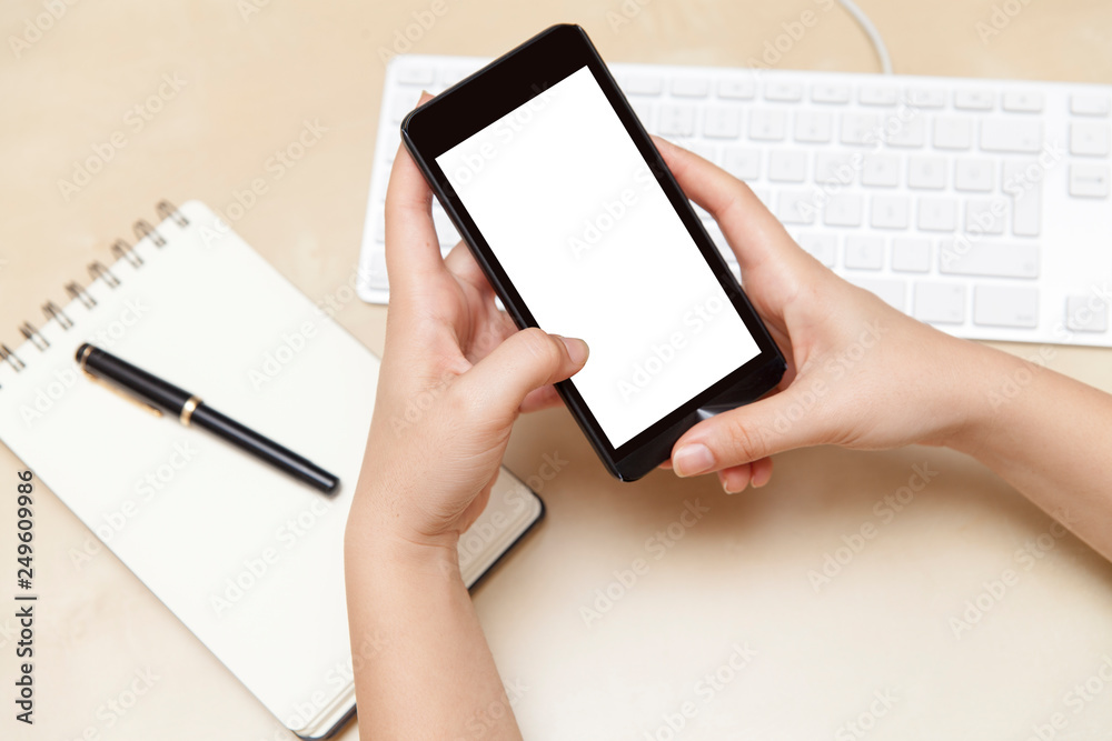 Hands Holding Smart Phone on Work Desk Mock Up Hands Holding Smart Phone on Work Desk Mock Up