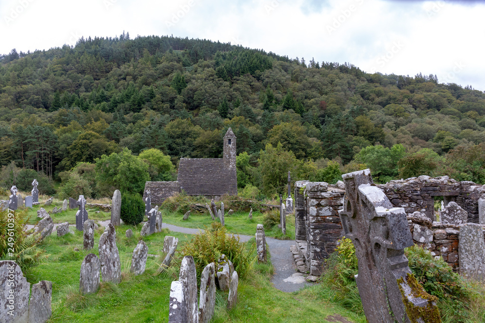 Ancient Celtic gravesite with unmarked gravestones and old rundown church