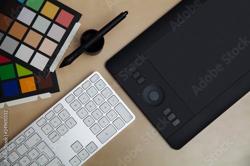 Retoucher and Graphic Designer Desk Concept with Keyboard and Tablet