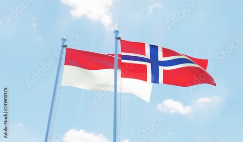 Norway and Indonesia, two flags waving against blue sky. 3d image