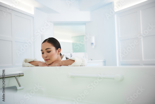 Beautiful asian lady lean on bath in beauty salon