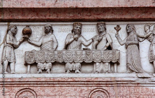 il banchetto di Erode; bassorilievo sull'architrave del portale nord del Battistero di Parma photo