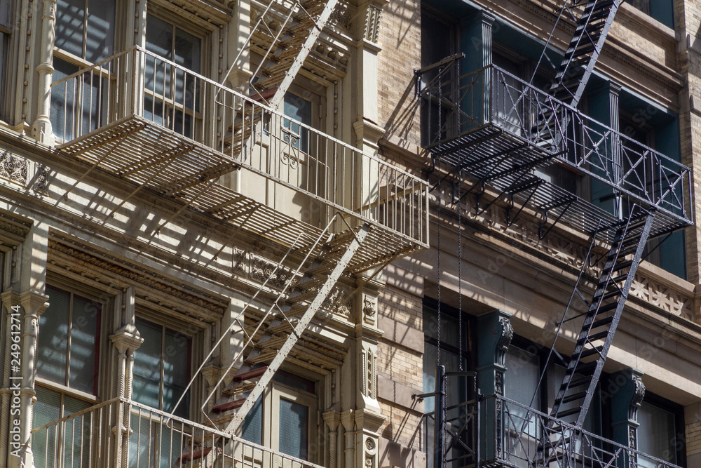 Fire escape stairs-downtown back alley architecture-steel and red brick background Fire escape stairs-downtown back alley architecture-steel and red brick background