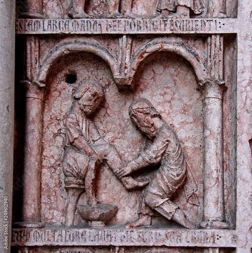 opere di misericordia corporale: curare gli ammalati; stipite del portale ovest del Battistero di Parma photo