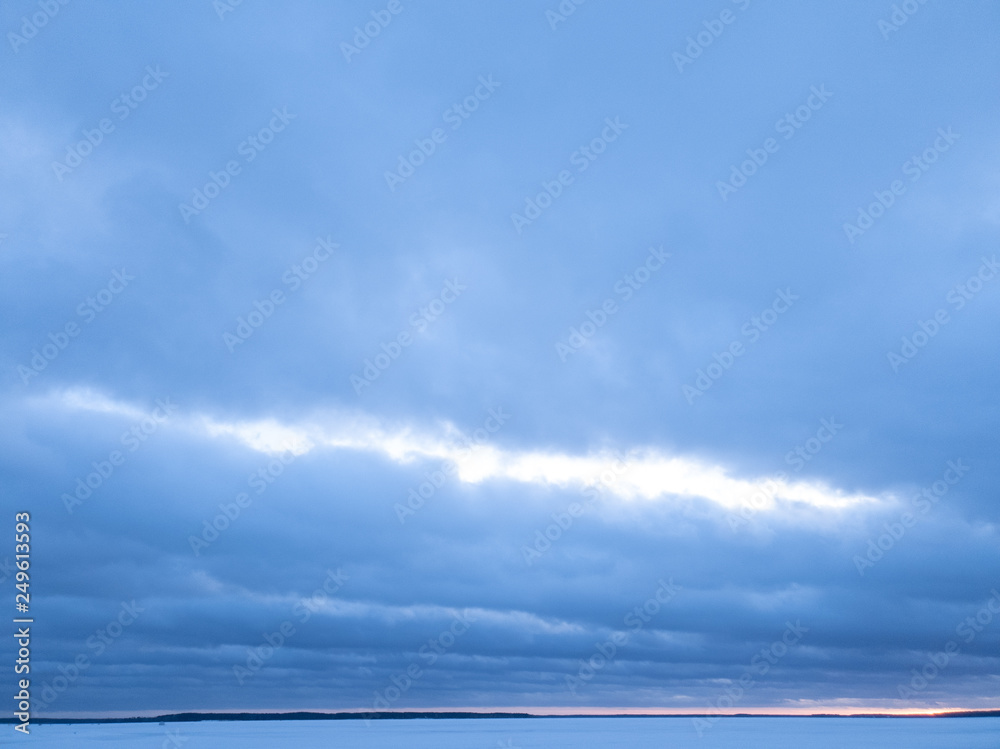 Сlouds in winter on the horizon of a frozen lake. Сlouds in winter on the horizon of a frozen lake.