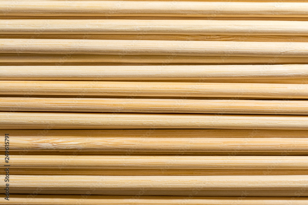 Obraz premium Round wooden sticks background. Close-up Wall Pattern