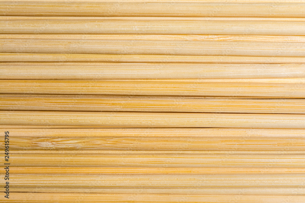 Round wooden sticks background. Close-up Wall Pattern Round wooden sticks background. Close-up Wall Pattern