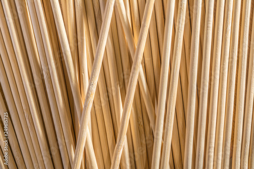 Round wooden sticks background. Close-up Wall Pattern