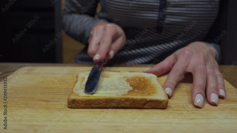 Closeup video: spreading chocolate butter on a piece of bread Closeup video: spreading chocolate butter on a piece of bread