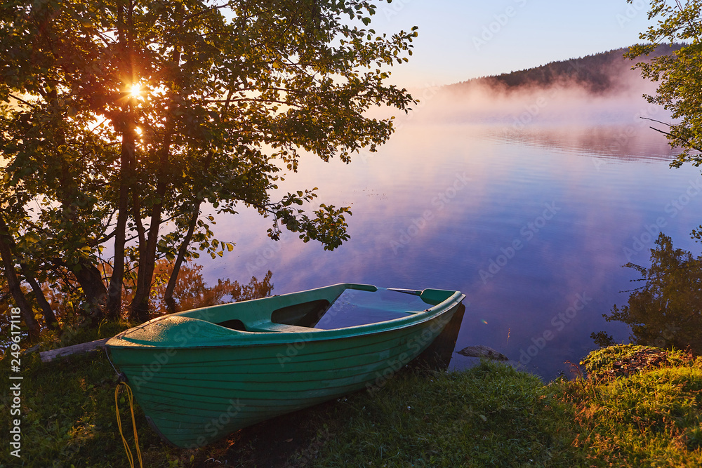 Peaceful morning landscape with fog and boats Peaceful morning landscape with fog and boats