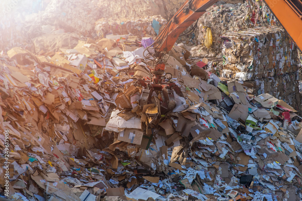 The waste paper is being cleaned up by a tong crane. The waste paper is being cleaned up by a tong crane.