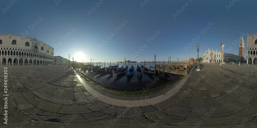 360 VR video. Morning scene of waterfront Riva degli Schiavoni with Doges Palace, St. Marks Campanile and gondola mooring. Workers cleaning the street