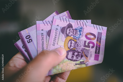 Holding money from Bolivia photo