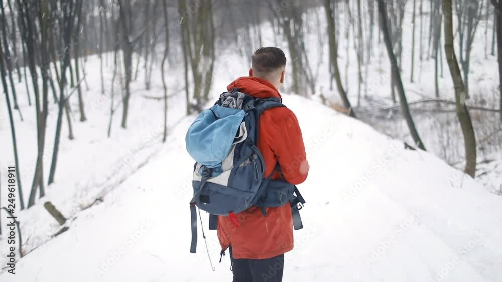 Young man Using mobile compass in forest Young man Using mobile compass in forest