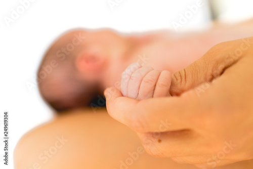 Small hands and fingers of newborn baby.