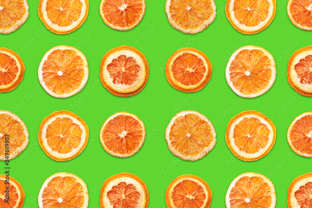 Cut orange fruit sections. Slices pattern design isolated on green background. Cut orange fruit sections. Slices pattern design isolated on green background.