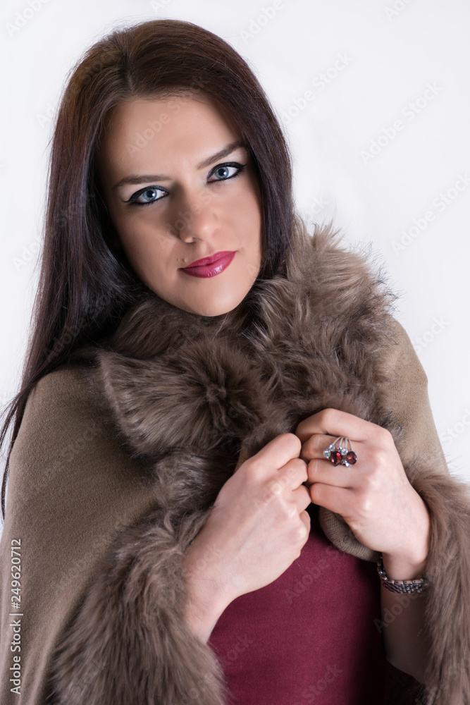 Fashion studio portrait of beautiful lady in brown fur coat and long ...