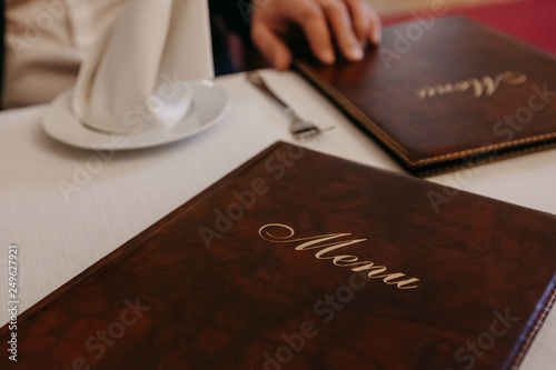 Man in restaurant reading the menu