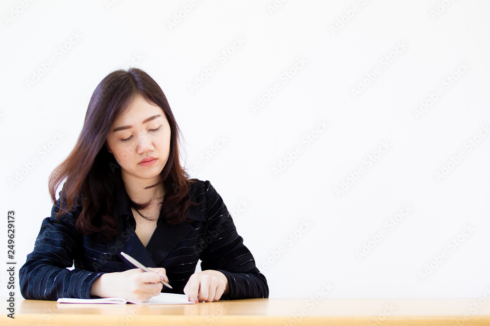 Portrait of Asian beautiful business women working on the wooden table in her office close up. Portrait of Asian beautiful business women working on the wooden table in her office close up.