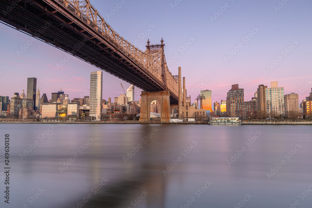 Queensboro bridge view from east river at sunrise with long exposure