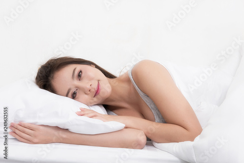 Portrait of a happy woman sleeping in the bed